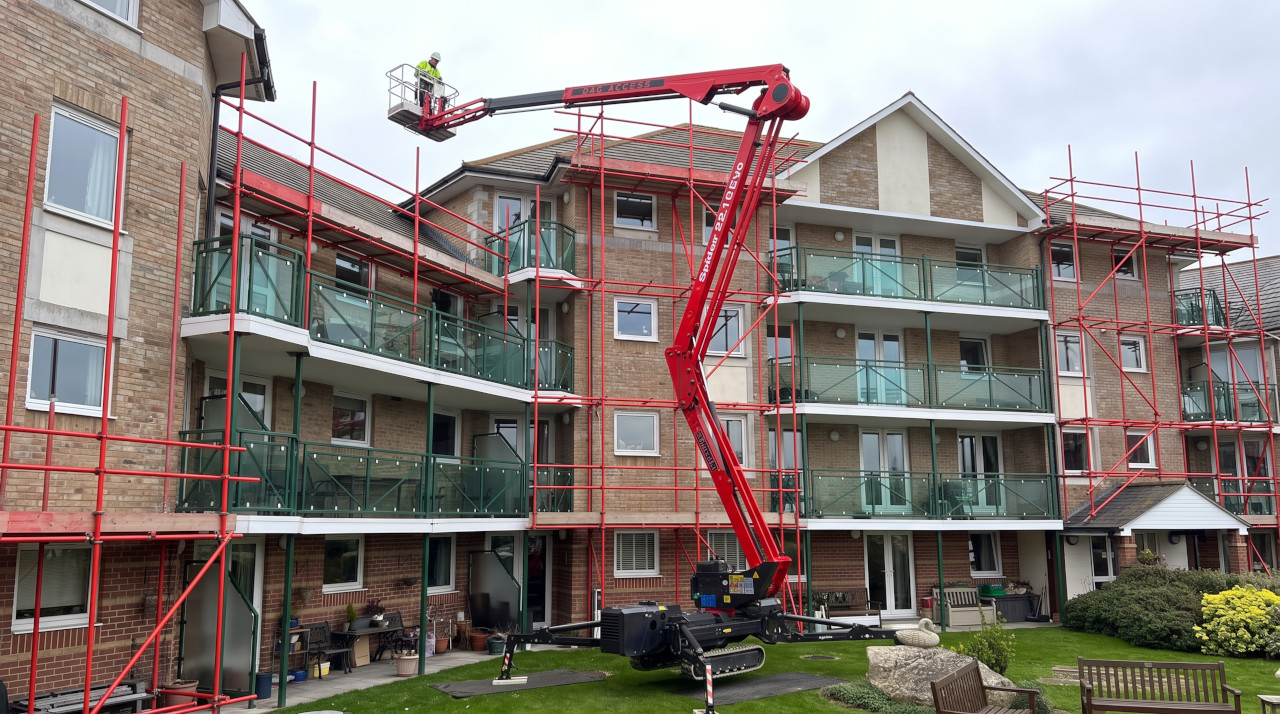 buidling with scaffolding and a cherry picker